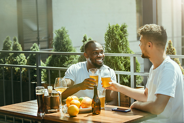 Image showing Young men drinking beer and celebrating together