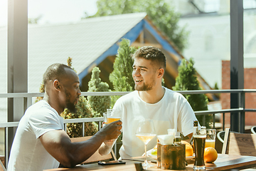 Image showing Young men drinking beer and celebrating together