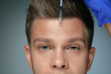 Image showing Close-up portrait of young man isolated on grey studio background