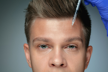 Image showing Close-up portrait of young man isolated on grey studio background