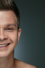 Image showing Close-up portrait of young man isolated on grey studio background