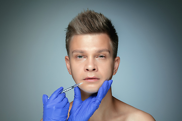 Image showing Close-up portrait of young man isolated on grey studio background