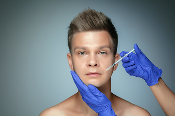 Image showing Close-up portrait of young man isolated on grey studio background