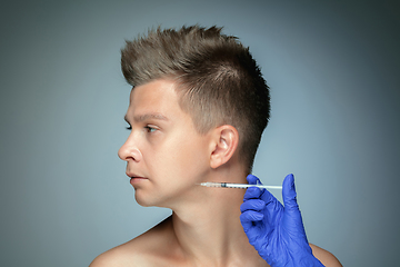 Image showing Close-up portrait of young man isolated on grey studio background