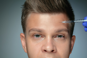 Image showing Close-up portrait of young man isolated on grey studio background