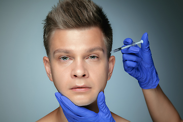 Image showing Close-up portrait of young man isolated on grey studio background