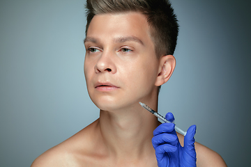 Image showing Close-up portrait of young man isolated on grey studio background