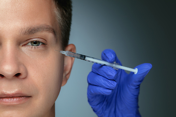 Image showing Close-up portrait of young man isolated on grey studio background