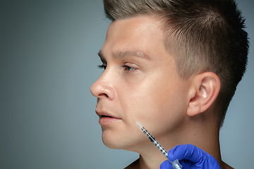 Image showing Close-up portrait of young man isolated on grey studio background