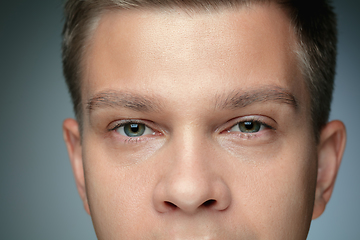 Image showing Close-up portrait of young man isolated on grey studio background