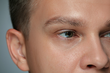 Image showing Close-up portrait of young man isolated on grey studio background