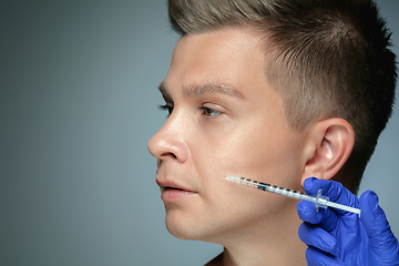 Image showing Close-up portrait of young man isolated on grey studio background