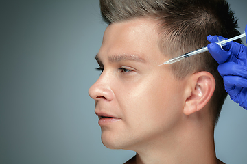 Image showing Close-up portrait of young man isolated on grey studio background