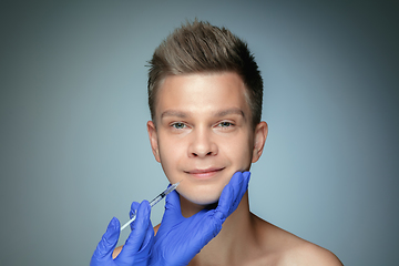 Image showing Close-up portrait of young man isolated on grey studio background