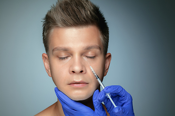 Image showing Close-up portrait of young man isolated on grey studio background