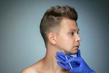 Image showing Close-up portrait of young man isolated on grey studio background