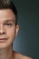 Image showing Close-up portrait of young man isolated on grey studio background