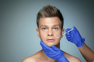 Image showing Close-up portrait of young man isolated on grey studio background