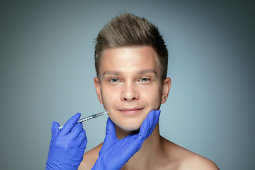 Image showing Close-up portrait of young man isolated on grey studio background