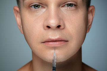 Image showing Close-up portrait of young man isolated on grey studio background