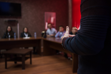 Image showing successful businessman giving presentations at conference room