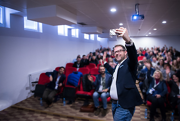 Image showing businessman taking selfie at conference room