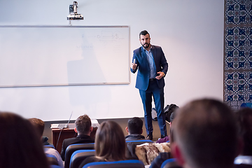 Image showing successful businessman giving presentations at conference room