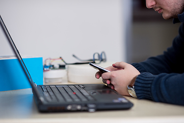 Image showing Young casual businessman using smartphone