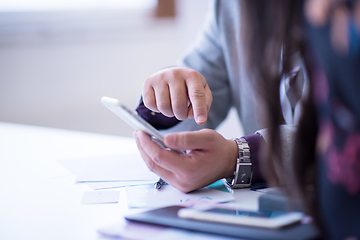 Image showing Young casual businessman using smartphone