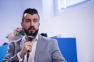 Image showing successful businessman giving presentations at conference room