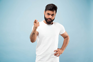 Image showing Half-length close up portrait of young man on blue background.