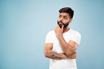 Image showing Half-length close up portrait of young man on blue background.