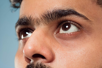 Image showing Close up portrait of young man on blue background.