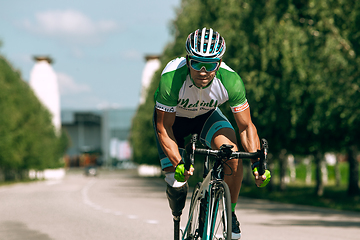 Image showing Dnipro, Ukraine - July 12, 2019: athlete with disabilities or amputee training in cycling