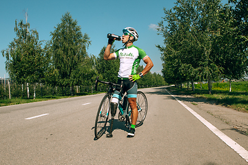 Image showing Dnipro, Ukraine - July 12, 2019: athlete with disabilities or amputee training in cycling