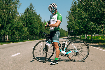 Image showing Dnipro, Ukraine - July 12, 2019: athlete with disabilities or amputee training in cycling