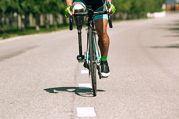 Image showing Dnipro, Ukraine - July 12, 2019: athlete with disabilities or amputee training in cycling