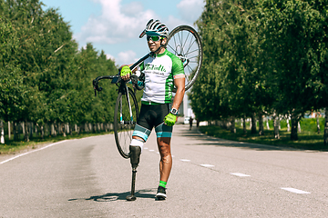 Image showing Dnipro, Ukraine - July 12, 2019: athlete with disabilities or amputee training in cycling