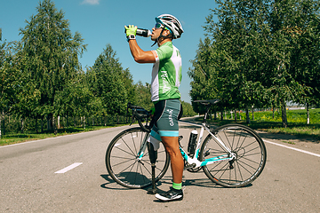 Image showing Dnipro, Ukraine - July 12, 2019: athlete with disabilities or amputee training in cycling