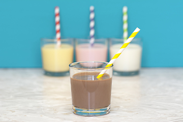 Image showing Chocolate milkshake in front of a row of flavoured milkshakes