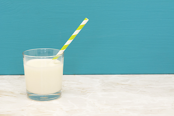 Image showing Creamy, fresh milk with a straw in a glass