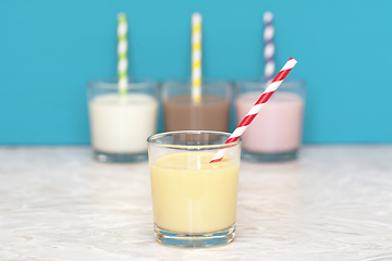 Image showing Banana milkshake in front of a row of flavoured milkshakes