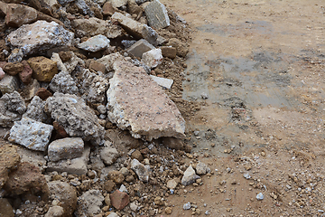 Image showing Broken pieces of concrete and bricks next to excavated ground