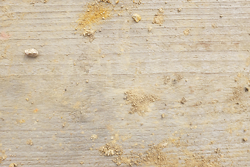 Image showing Smooth wooden board background, covered with crumbled earth and 