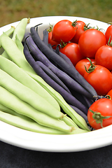 Image showing Beans and ripe tomatoes in a white ceramic dish 