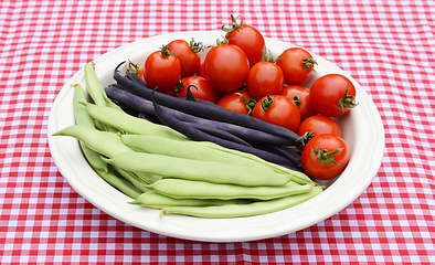 Image showing Green yin yang beans, purple French beans and juicy tomatoes 