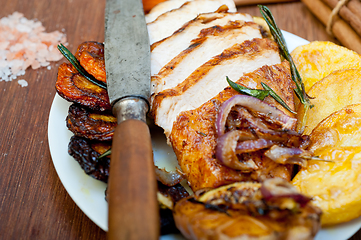 Image showing roasted grilled BBQ chicken breast with herbs and spices 