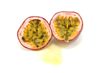 Image showing Passion fruit cut in half showing yellow pulp around seeds