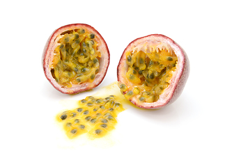 Image showing Passion fruit cut in half with juicy yellow pulp and seeds