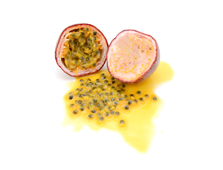 Image showing Half passion fruit with sweet pulp, seeds and juice spilled 